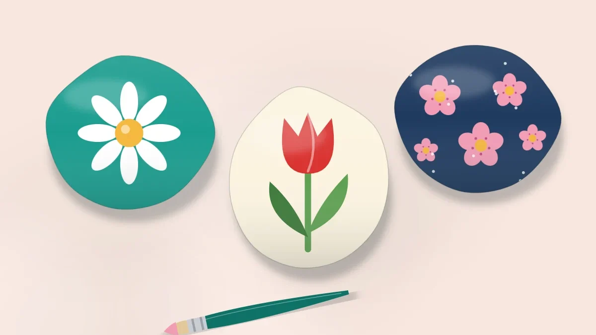 Three stones with painted flowers: a white daisy on teal, a red tulip on cream and pink blossoms on navy, with a round brush beside them