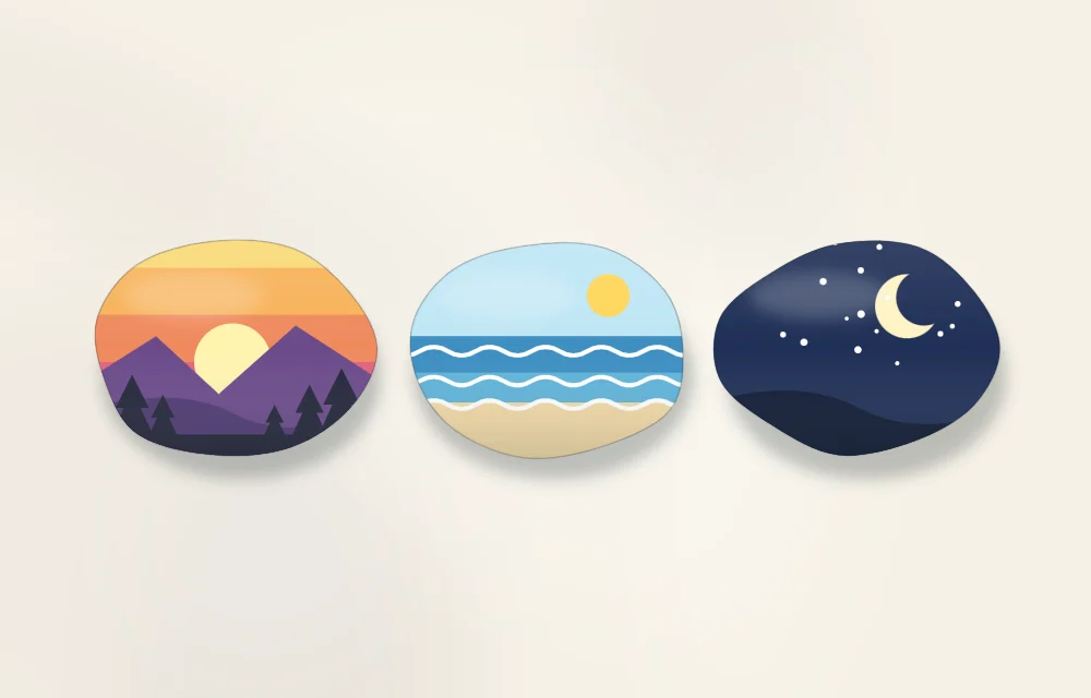 Three small landscape stones: a sunset over mountains, a beach with blue waves, and a night sky with a moon and stars