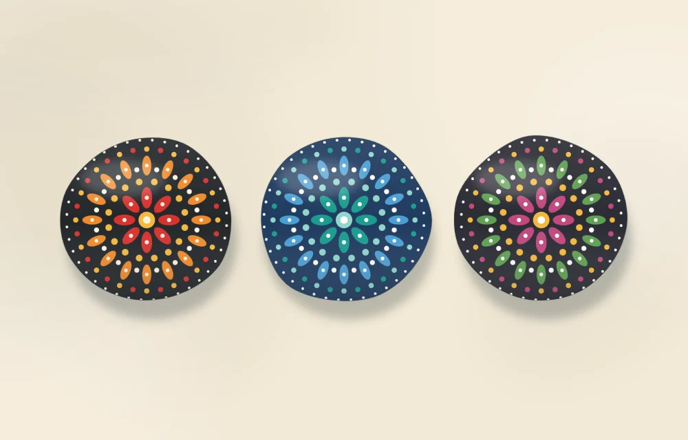 Three finished radial-pattern stones in different color palettes: warm, cool and rainbow