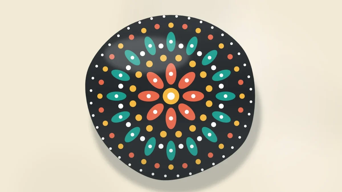 A round black stone with an original radial pattern built from rings of dots and petal shapes in teal, coral, yellow and white
