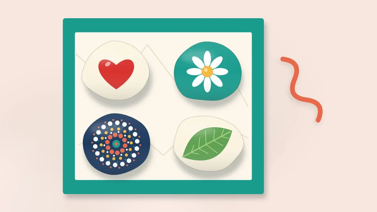 An open gift box lined with tissue paper holding four painted stones (a heart, a flower, a dot pattern and a leaf) with a ribbon beside it