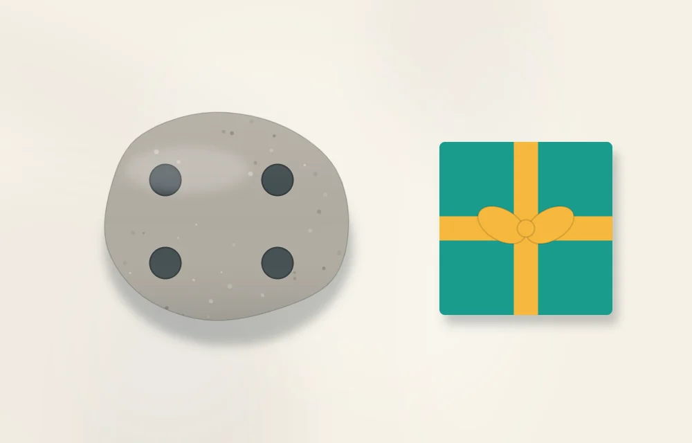 Underside of a stone with four small felt pads, next to a small gift box with a ribbon