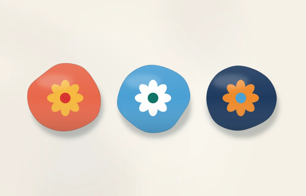 The same simple flower design on three stones in three palettes: warm colors, cool colors and a pair of opposite colors