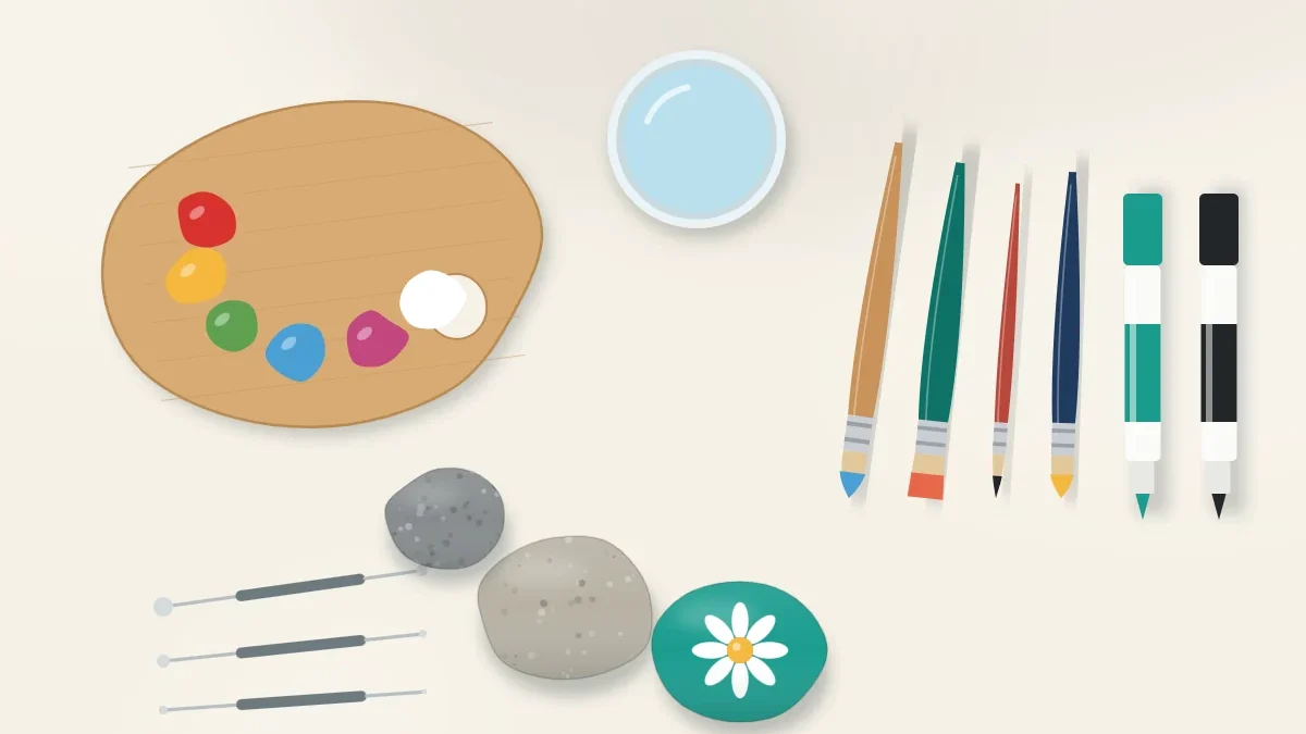 Craft workspace seen from above with a wooden palette of paint, a jar of water, four brushes, two paint pens, dotting tools and several stones